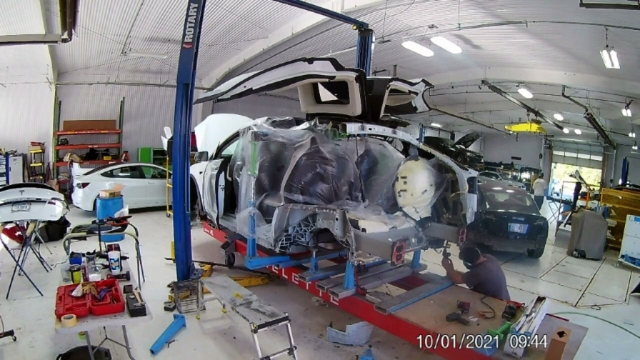 Tesla Model X quarter panel, rear body and floor replacement on Celette Sevenne XL bench