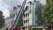 More than 100 firefighters have been tackling a massive fire at flats