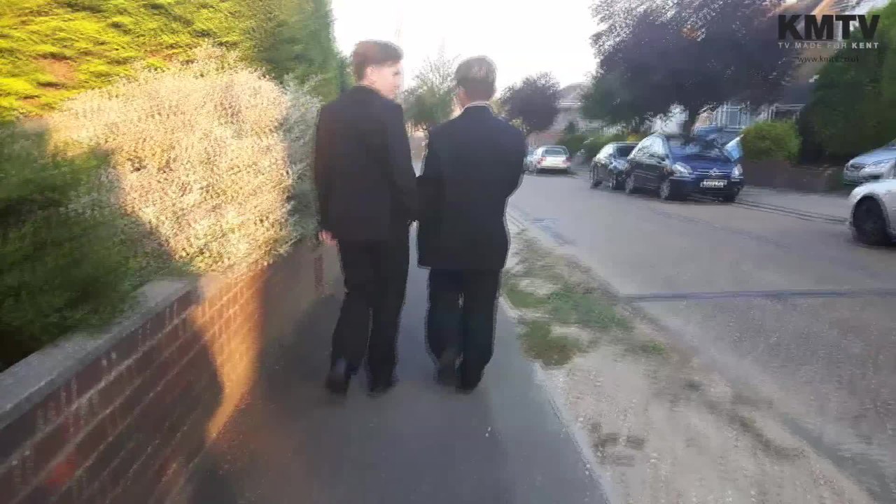 Two school friends help a collapsed man