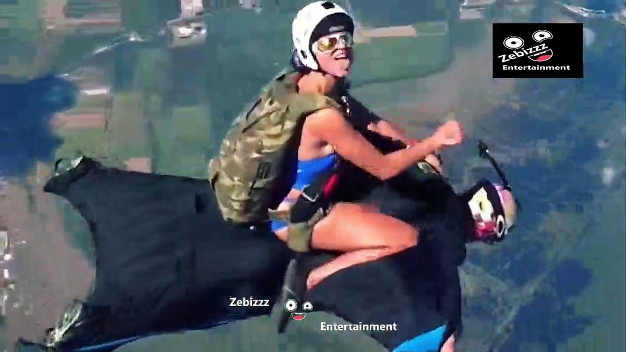 woman riding a man during parachute jump