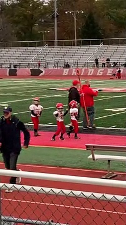 Peewee Football Player Grooves Away on the Sidelines