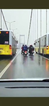2 chauffeurs de bus protègent des motards de brosses bourrasques de vent sur un pont