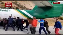 Passengers pushes Tara Airlines plane in Nepal
