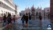 Tourists wade through floodwater in Venice's St. Mark's square