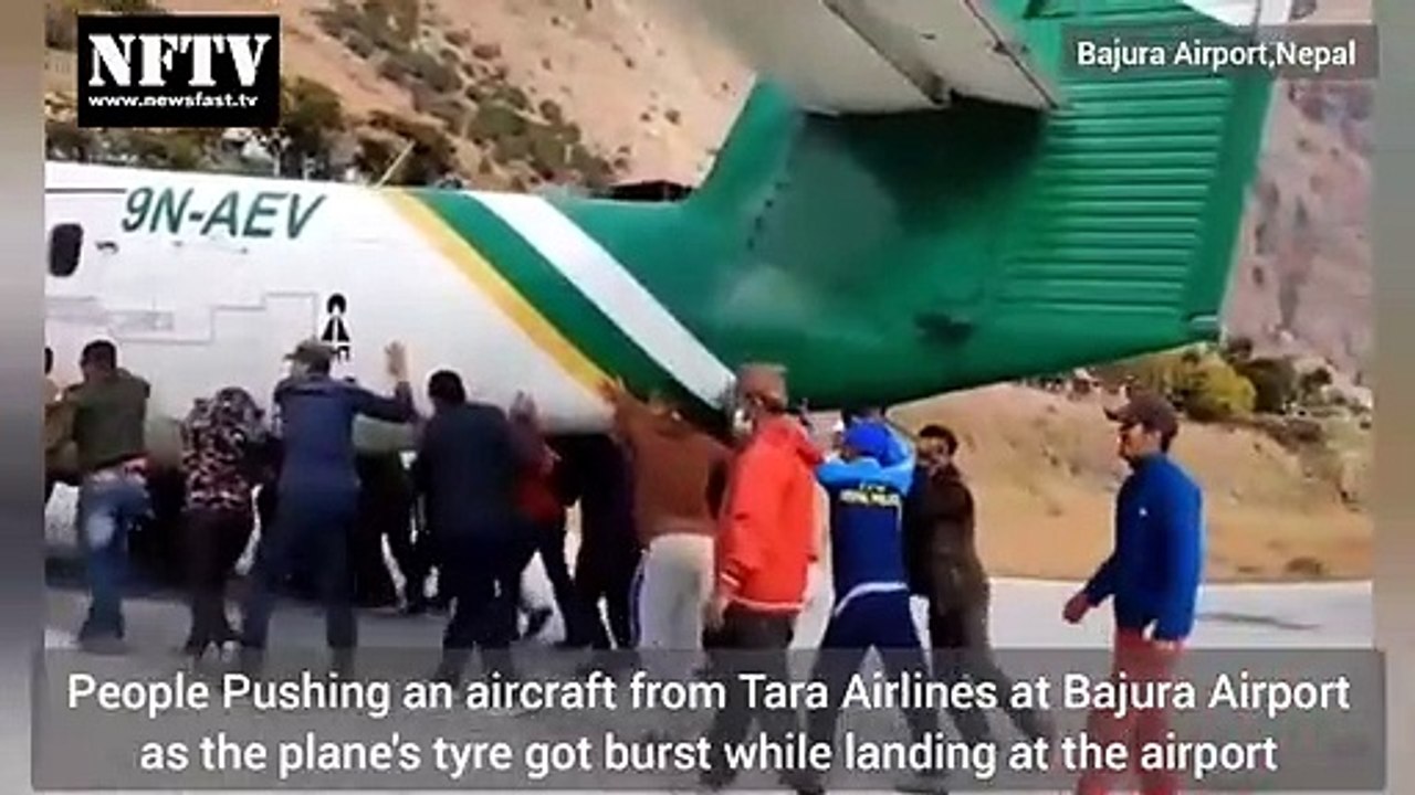Passengers Pushing Tara Airlines plane at Bajura Airport Nepal