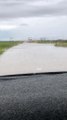 Truck Driving on Flooded Roads Covers Car