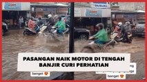 Pasangan Naik Motor di Tengah Banjir Curi Perhatian, Warganet: Iri Meronta