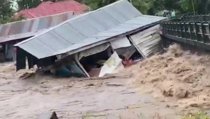 Powerful floodwaters wash away two homes in Indonesia