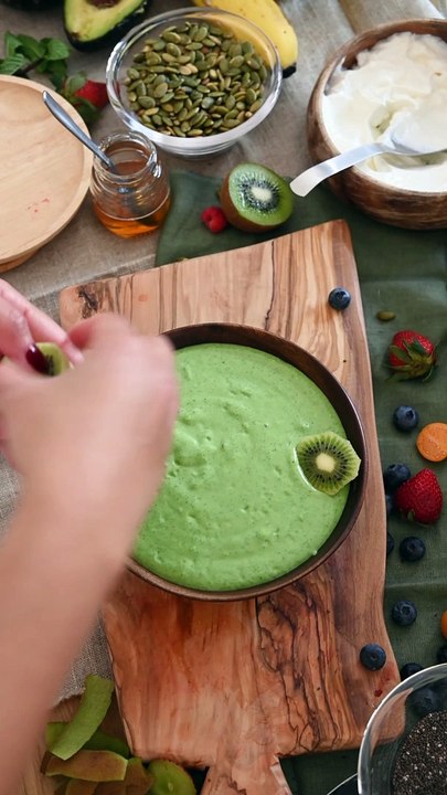 Person Decorating Dessert With Kiwi