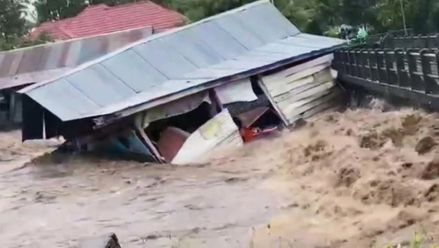 Watch as heavy rainfall in Indonesia washes away homes and floods streets