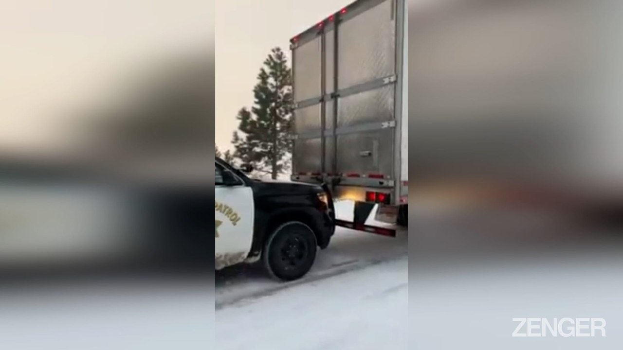 Cop Patrol Car Gives Snow Stranded Truck A Push.mp4