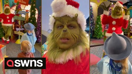 This amazing grinch impersonator is caught on camera having an adorable interaction with two young children.