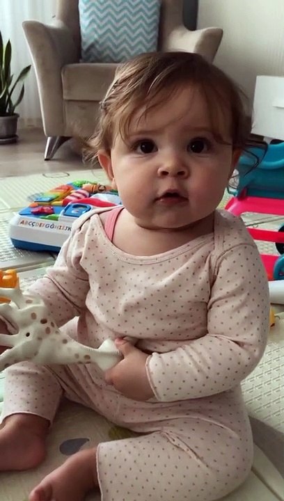 Small cute baby playing with her toys, so so cute fun