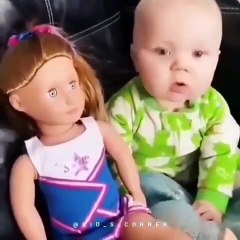 cute baby staring at the doll