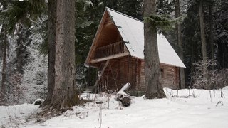 video a snow covered log cabin