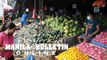 Vendors prepare round-shaped fruits at Bankerohan Market in Davao City