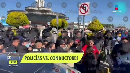 Conductores de plataformas y polcías protagonizan pelea en Puebla