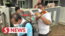 Volunteers provide medical aid to victims post-flood in Taman Sri Nanding