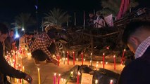 إضاءة شموع في مطار بغداد في الذكرى الثانية لاغتيال سليماني والمهندس