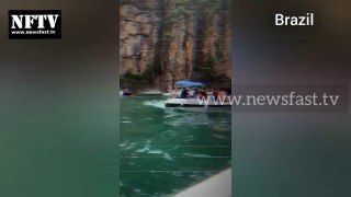 A large rock fell from a cliff and landed on tourist boats drifting on a Brazilian lake