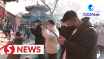 Foreigners pray at Beijing’s Yonghe Lama temple