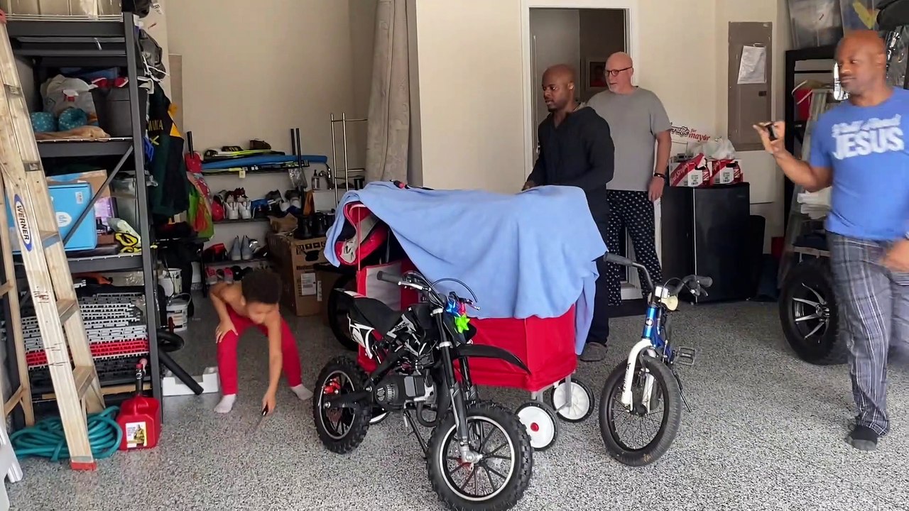 Son Listening to Dad is Oblivious to Dirt Bike Christmas Present