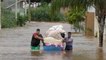 Brazilians remove belongings from flooded homes