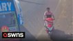 Man onboard scooter narrowly misses bus as it sped around the corner in India