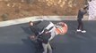 Students Slide on Street on Windy Day Using Sheets While Balancing on Chairs And Skateboards