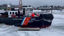 Icebreaking boat smashes through frozen river