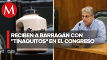 Comparece Juan Ignacio en Congreso; lo reciben con mini tinacos y pancartas