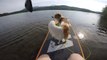 Dog Hops on Edge of Paddle Board to go For Adventure in Water With Owner