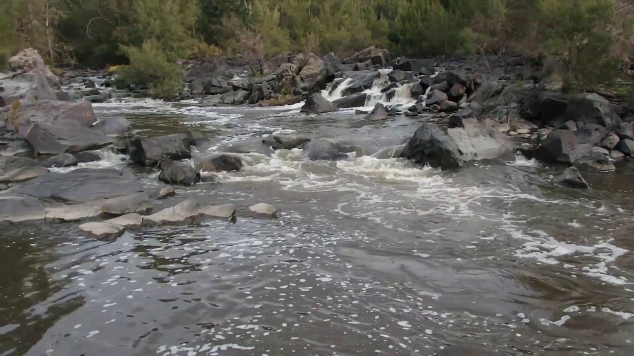 WONDERFUL SCENE OF WATER FLOWING THROUGH ROCKS AND HILL