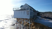 Coastal home threatened by beach erosion