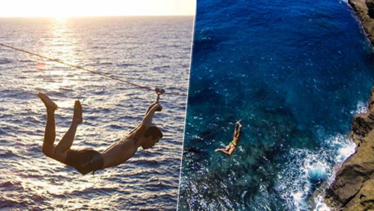 Unglaubliche Sprünge mittels einer Zip-Line von einer Felswand.