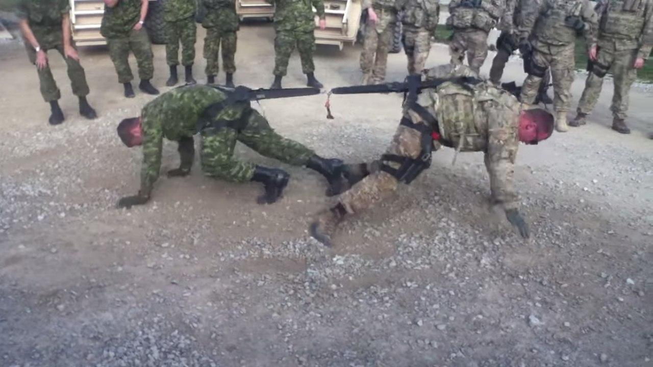 Ein amerikanischer und ein kanadischer soldat liefern sich einen sportlichen kampf
