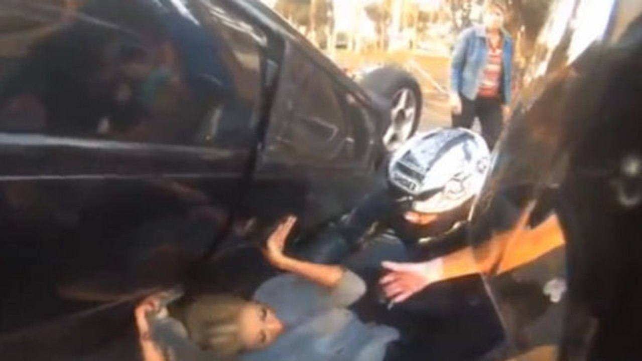 Diese Frau hatte das Glück, dass dieser Motorradfahrer vorbeikam, als sie unter ihrem Auto eingeklemmt war