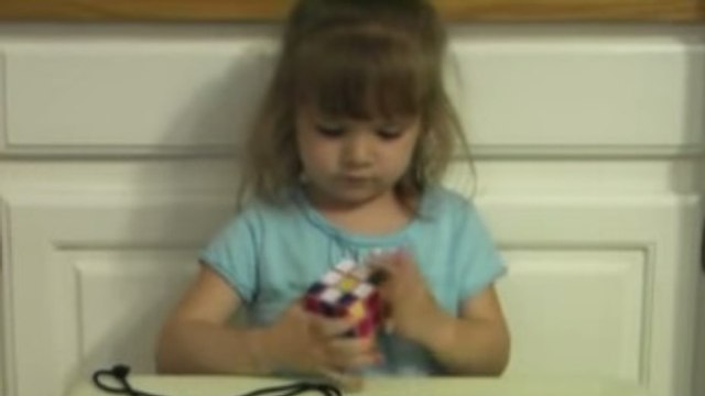 Cette petite fille est très douée pour le Rubik's Cube. Elle le finit en un temps record.