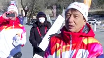 Actor Jackie Chan carries Olympic torch atop Great Wall