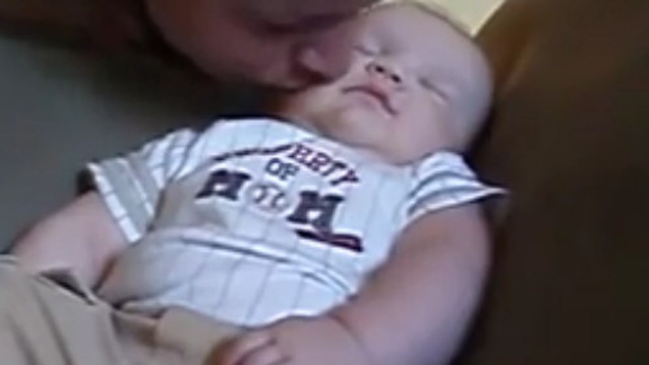 Ce bébé endormi adore les bisous de son papa