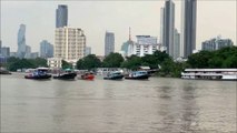 5 tugboats pulling a barge Chao Phraya river Bangkok Thailand