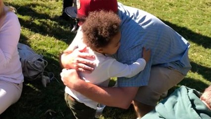 Un petit garçon fait une tournée de câlins à des inconnus dans un parc