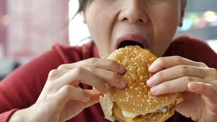 Woman chews on rotting finger while eating hamburger