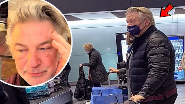 Alec Baldwin looked dazed as he appeared at London's Heathrow Airport