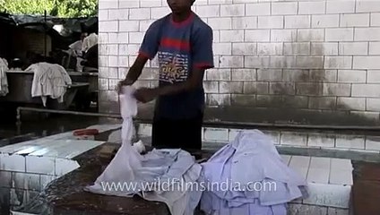 Washer man washing clothes in Dhobhi ghat
