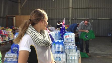 Ashleigh Mills and Lucy Moore visit Aussie Helpers with some welcome funds.