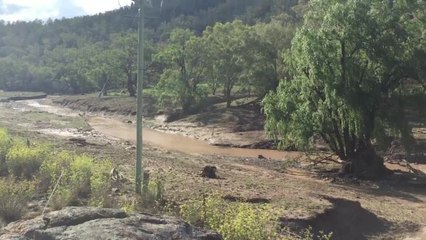 Water from Werries Creek pouring over the wall on the Gap Road.