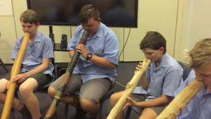 St Mary's College students playing didgeridoo.