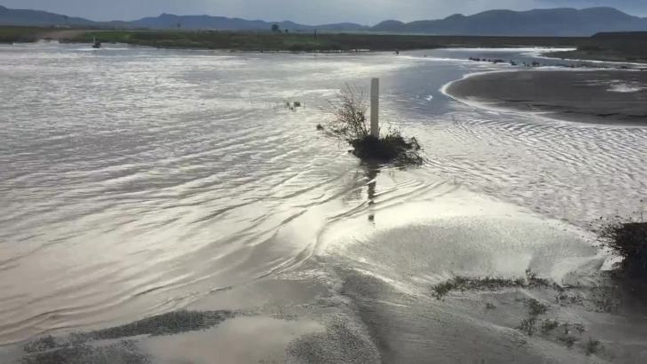 Water flowing across a floodway on Bulunbulun Road in Breeza.