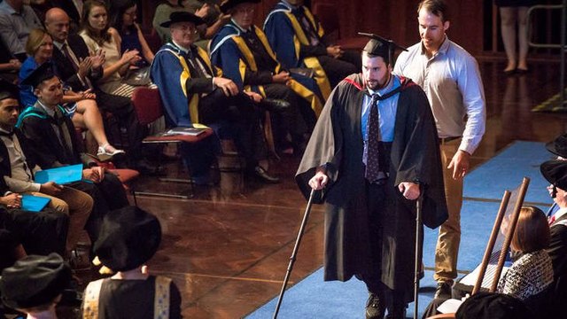 Paralysed student uses robot legs to walk on stage at graduation